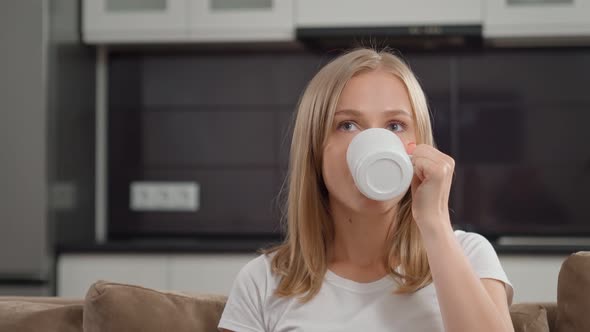 Woman Eating Cookies Drinking Tea and Watching Movie