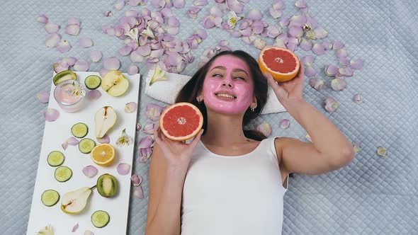 Smiling Young Woman Posing on the Camera with Grapefruit 