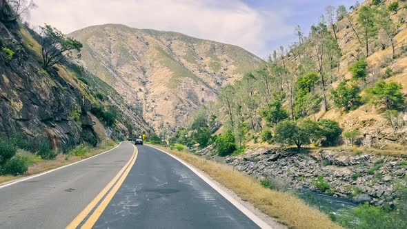 A View of a Road in the Mountains of California Through the Windshield of a Car