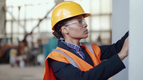 Serious woman engineer working in uniform