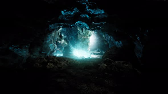 Blue Ice Cave Covered with Snow and Flooded with Light