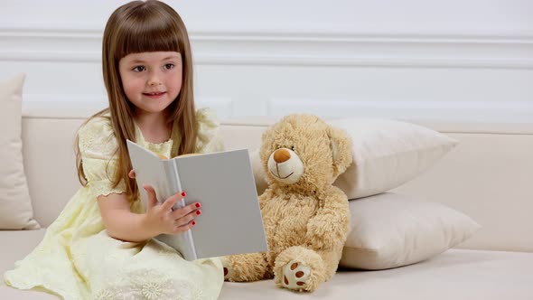 Girl with Teddy Bear Reading a Book