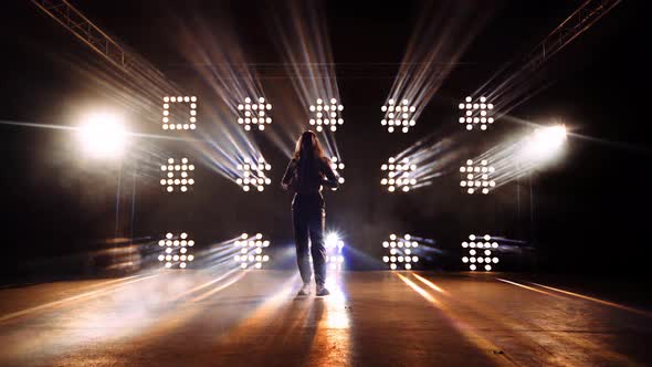 Spotlights Rotating in Different Symbols on the Wall with Dancer on Stage