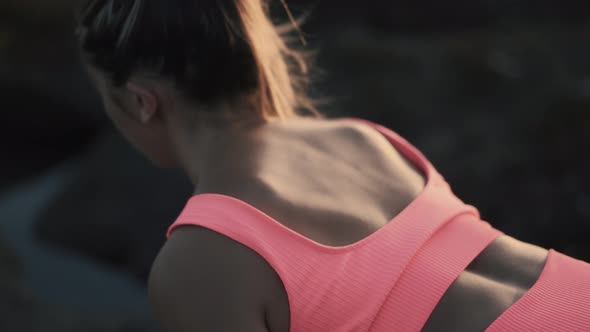 Side View Beautiful Young Woman Doing Exercises with Elastic Band Outdoor