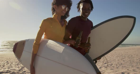 Couple walking together with surfboard on the beach 4k