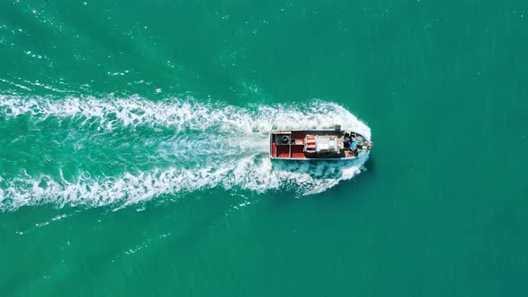 Aerial Footage of a Boat Carrying Load Within Turquoise Ocean Waters