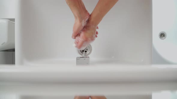 Female Hands Washing In Basin. Hygiene during coronavirus. A woman washes her hands