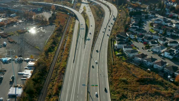 Aerial view of a busy highway through a suburban neighborhood.