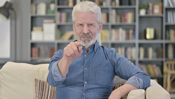 Cheerful Old Man Pointing at the Camera