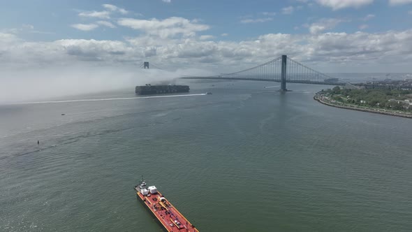 An aerial view of Gravesend Bay in Brooklyn, NY on a cloudy day with dense fog over the water. The c