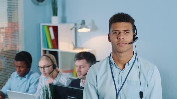 Portrait of Multiracial Customer Service Operator in Headset Smiling To the Camera