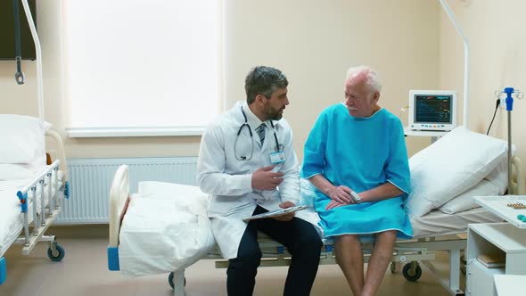 Old man sitting on therapy bad near doctor