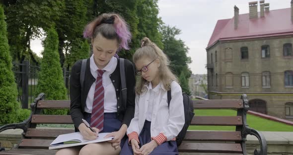 Two Schoolgirls Sitting on Bench, Primary and High School Student.