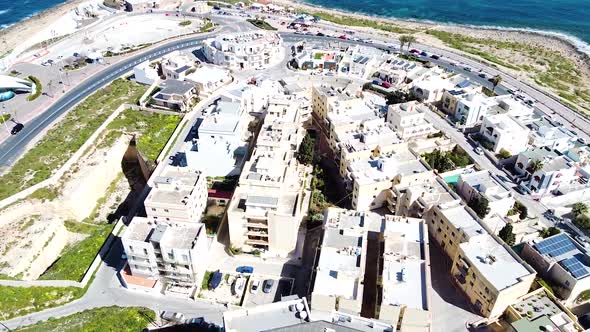 Coastline and residential buildings of St. Paul Bay in Malta, aerial view