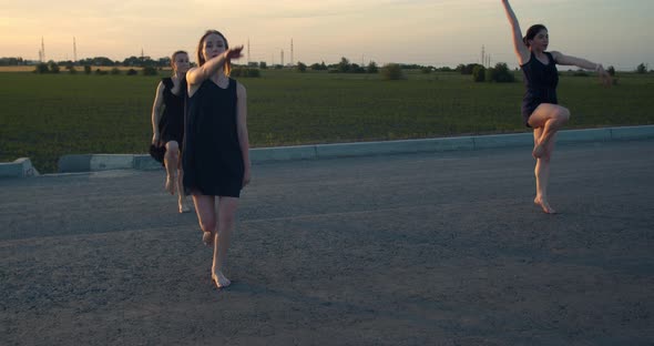 Three Beautiful Young Women Dancing Early in the Morning Outdoors Film Grain