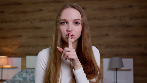 Young Woman Asking to Be Quiet with Finger on Lips Not to Tell the Secret Hush Zipping Her Mouth