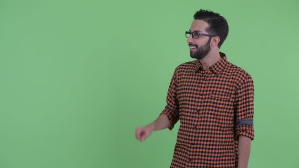 Happy Young Bearded Persian Hipster Man Touching Something and Looking Surprised