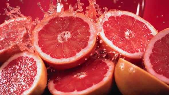 Slow Motion Shot of Grapefruit Juice Splashing Through Grapefruit Slices