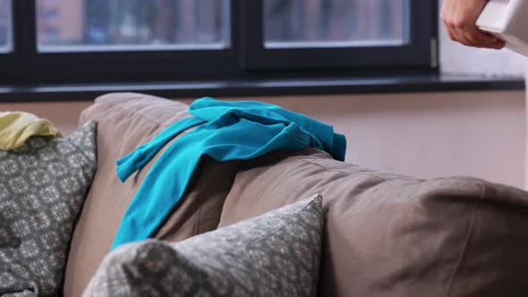 Senior Woman Picking Clothes for Laundry at Home