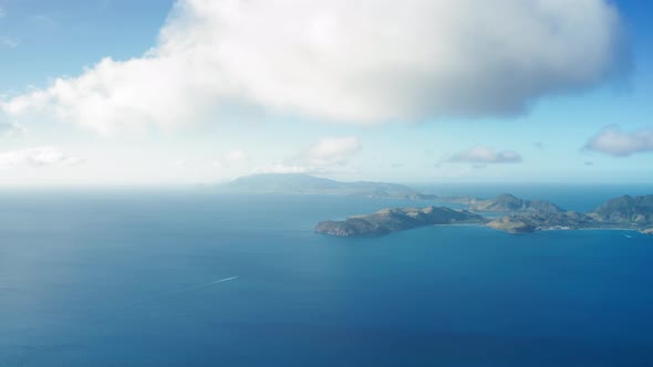 Aerial view of clouds moving over a hilly island in Saint Kitts and Nevis