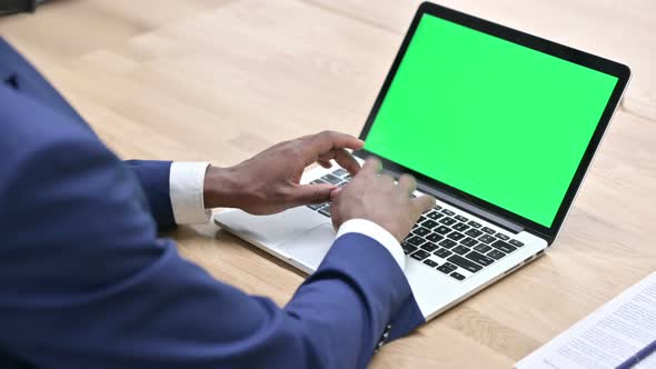 African Man Working on Laptop with Chroma Screen