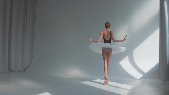 Female Dancer Does Ballet Exercises in Stage Dress with Open Back, Rehearses Dance Moves 
