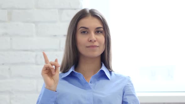 Hispanic Young Woman Waving Finger to Refuse