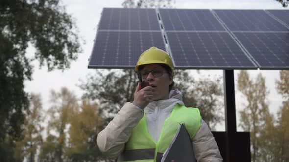 Worker inspects the solar panels and reports the information to the management
