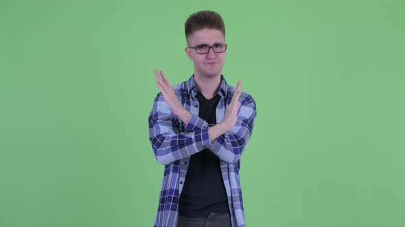 Serious Young Hipster Man with Stop Gesture