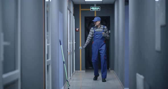 Janitor Checking Rooms in Building