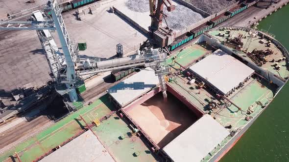 Loading Grain Onto a Cargo Ship for Transportation By Sea By a Conveyor Belt Machine