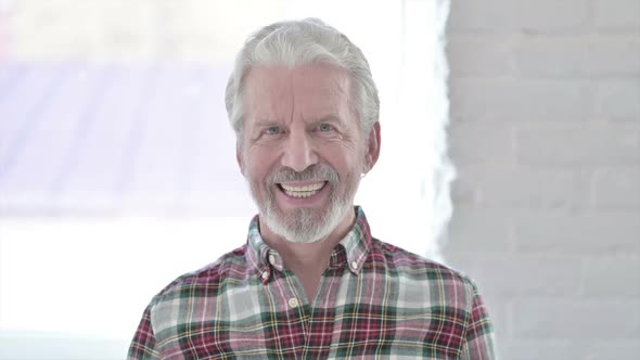 Portrait of Old Male Designer Looking at the Camera and Smiling