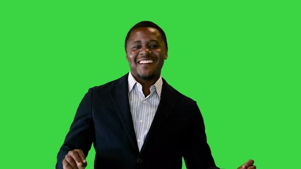 Smiling Handsome Male Business Man Celebrates Good News By Dancing on a Green Screen, Chroma Key