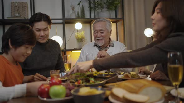 Asian family having dinner at dining table at home