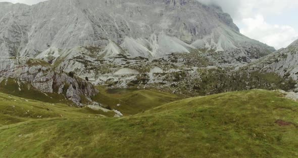 Aerial Drone Flight Establisher Over Green Cloudy Mountains Peaks