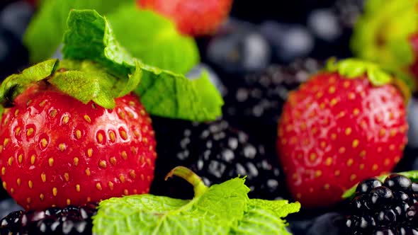 Footage of Camera Flying Over Lots of Berries and Mint Leaves Lying on Table