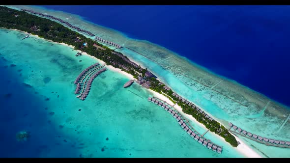 Aerial flying over panorama of exotic shore beach vacation by blue sea with white sand background of