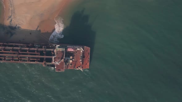 Old shipwreck on a beach near Varkala in Kerala, India. Top down aerial drone view