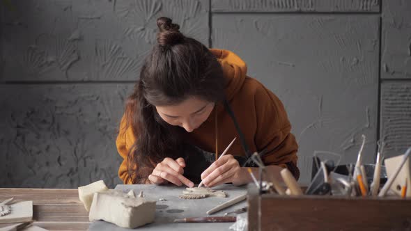 Talented Female Artist Work with Different Pottery Tools