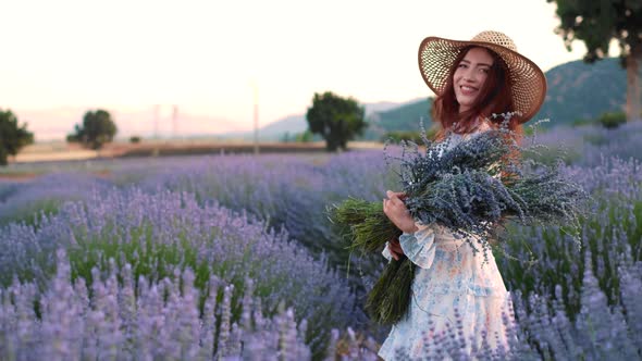 Woman in Lavender Flowers Field at Sunset
