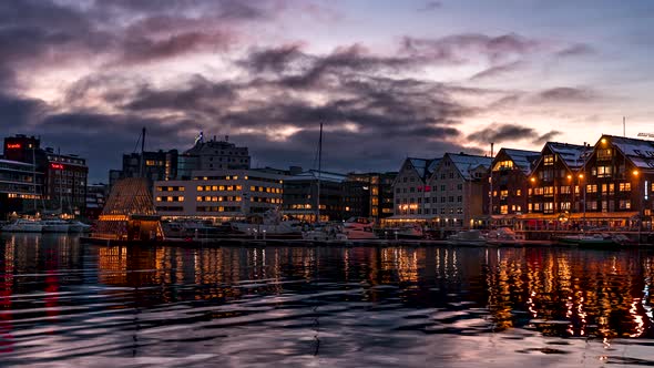 Illuminated buildings of Tromso Harbour at twilight, Norway, time lapse