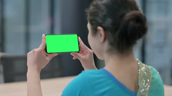 Indian Woman Looking at Smartphone with Chroma Key Screen