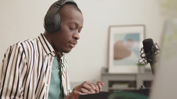 African-American Man Making Electronic Music at Home