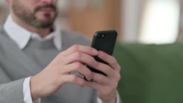 Close Up of Hands of Middle Aged Man Using Smartphone