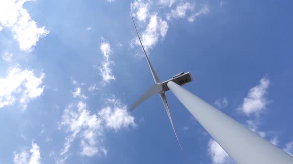 Wind Turbine View From Bottom Against Moving Clouds. Close Up