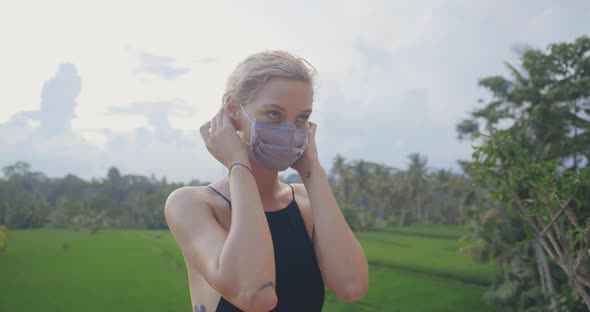 Young Girl Outdoors Putting Off Protective Mask and Enjoying Fresh Air