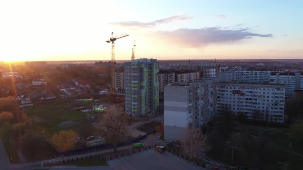 Construction Crane House At Sunset