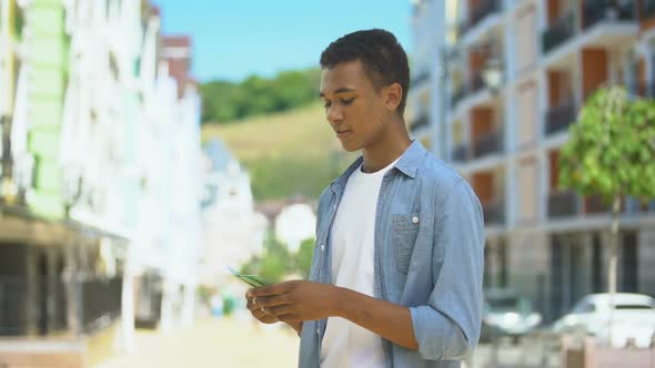 Joyful Afro-American Teen Male Counting Euros, Happy to Go Shopping, Income