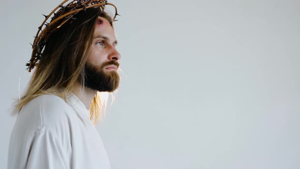 Jesus in a Crown of Thorns with Wounds on Face on a White Background