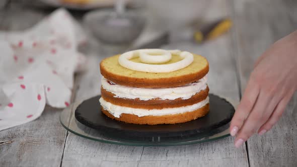 Female Chef Confectionery Making a Cake with a Cherry and Vanilla Cream